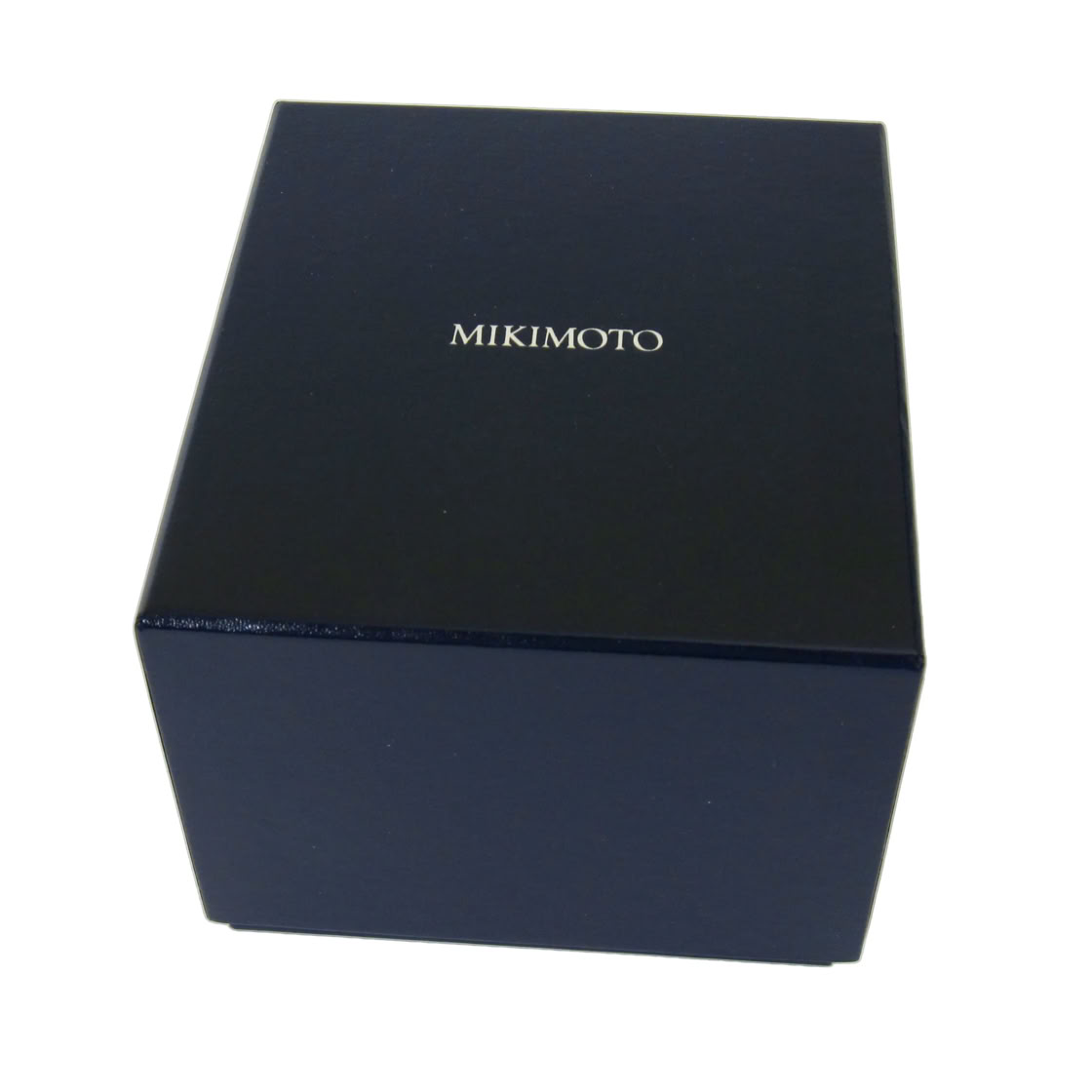 Blue rigid outer packaging designed for secure transport and refined presentation, marking the beginning of the Mikimoto luxury client experience