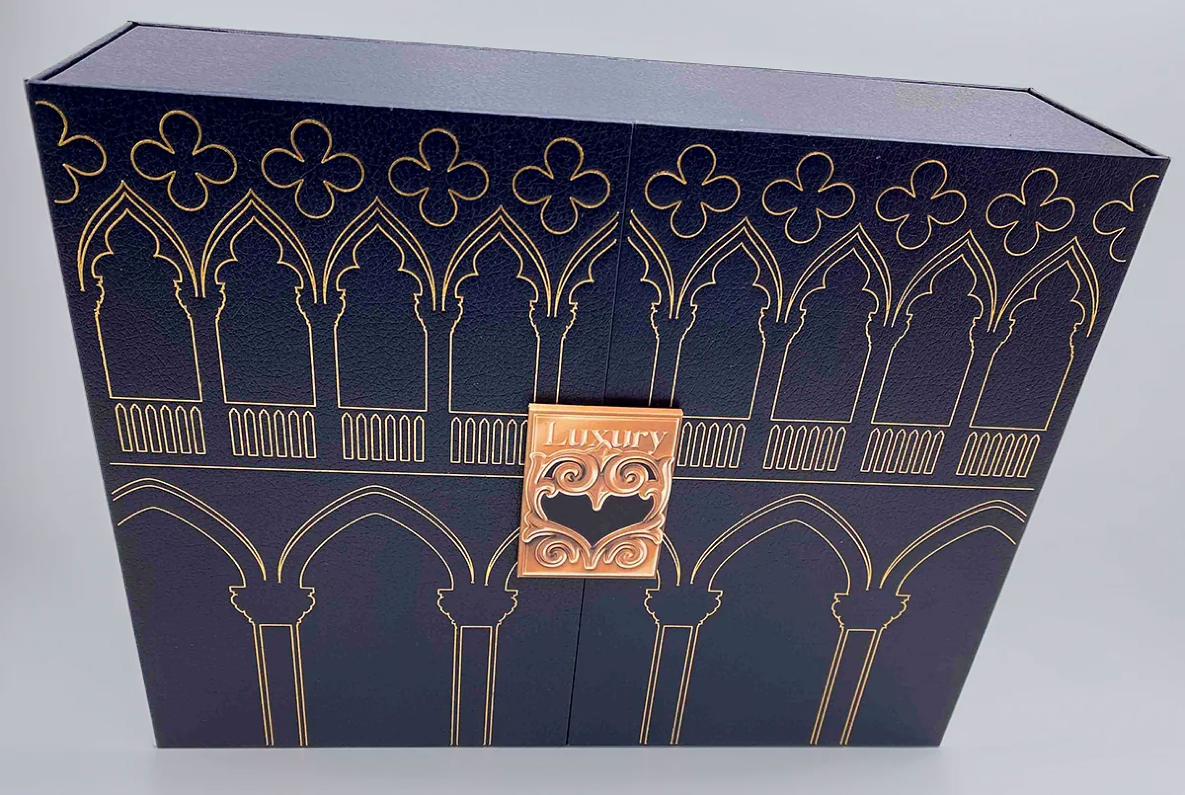 Luxury trade show invitation presentation box with architectural gold detailing and structured form designed to create a high-impact first impression by Swiss Packaging