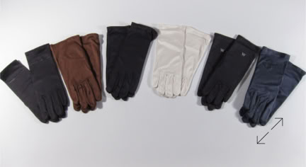 A row of six pairs of jewlers gloves in different colors: black, brown, black, white, black, and dark blue, arranged on a light gray background manufactured by Swiss Packaging of New York and Switzerland