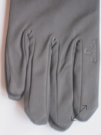 A gray jewelers glove with visible stitching and a small embroidered logo on the back manufactured by Swiss Packaging of New York and Switzerland