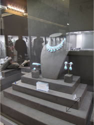 Basel Display Case Jewelry display case featuring a necklace, bracelet, and earrings set on a tiered riser; design of stand and displays by Swiss Packaging of New York and Switzerland