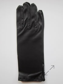A single black jewelers glove on a plain white background manufactured by Swiss Packaging of New York and Switzerland