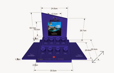 A blue jewelry display stand with multiple compartments and a central raised section featuring a small insert for  showing an image of a beach. The stand has various measurements labeled in centimeters.