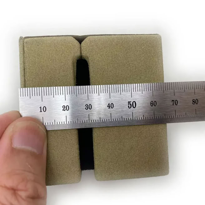 Precision measurement of luxury packaging components during quality control process at Swiss Packaging