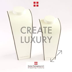 Two white mannequin necklace displays with the text "CREATE LUXURY" in the center, and a red square logo with four smaller squares above and below manufactured by Swiss Packaging of New York and Switzerland