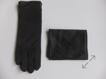 A black jewelers glove and a folded black cloth on a white surface manufactured by Swiss Packaging of New York and Switzerland